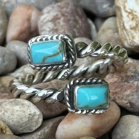 Ring that wraps around your finger and each end has a rectangle with a turquoise stone